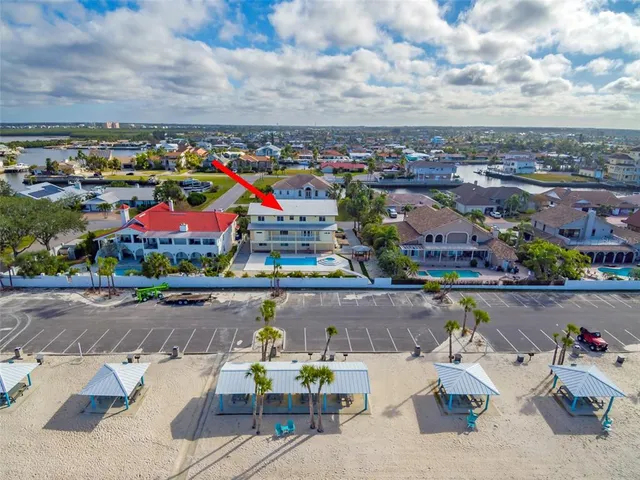 a view of a house with a yard and potted plants