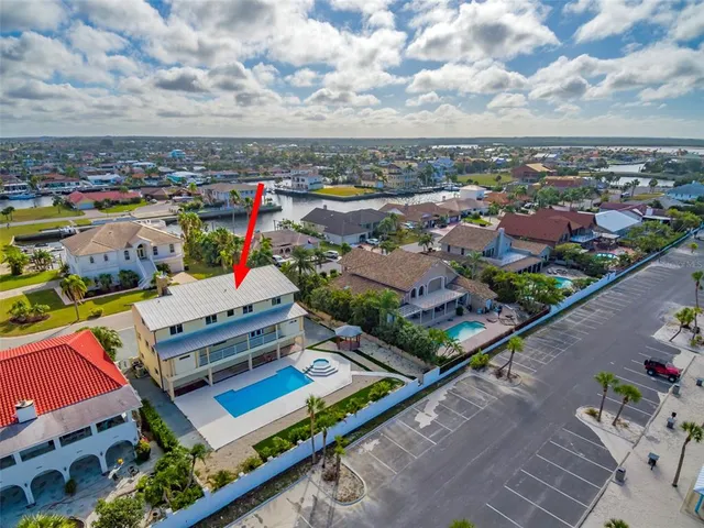a view of a house with backyard and trees