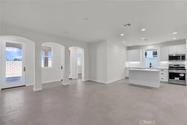 a view of kitchen with furniture and refrigerator
