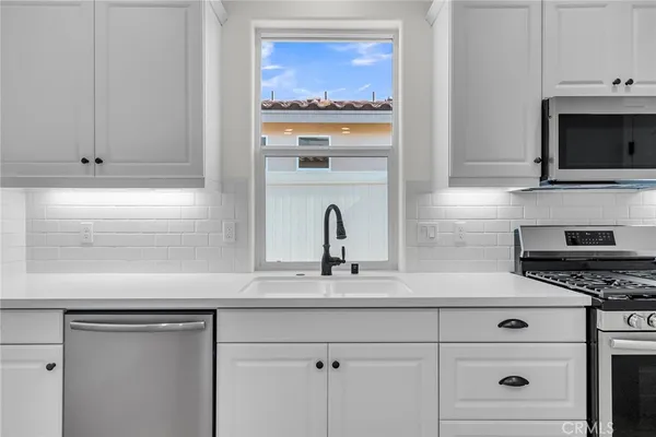 a stove top oven sitting inside of a kitchen