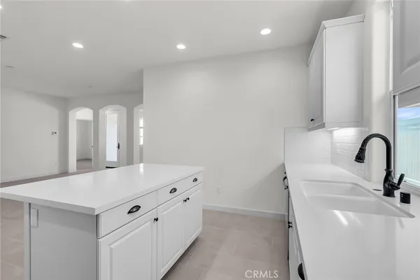 a kitchen with a sink and a refrigerator