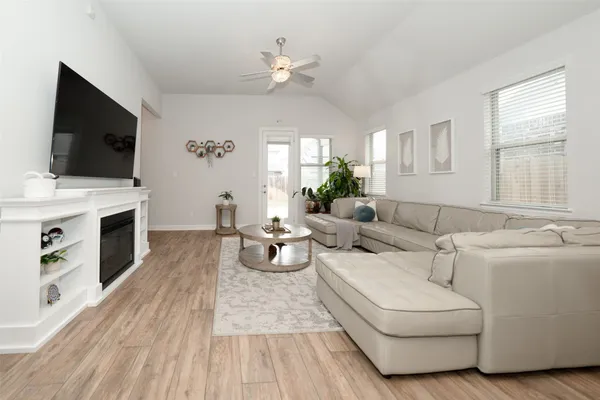 a living room with furniture fireplace and flat screen tv