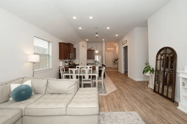 a living room with furniture and a wooden floor