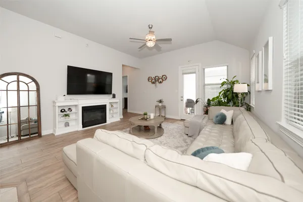 a living room with fireplace furniture and a flat screen tv