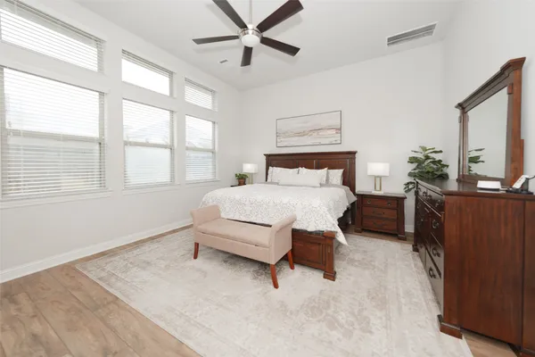 a bedroom with a bed and a flat tv screen