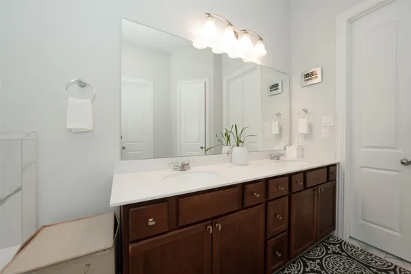 a bathroom with a sink a mirror and a shower
