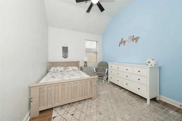 a bedroom with a bed and a dresser