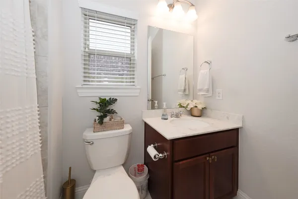 a bathroom with a toilet sink and mirror
