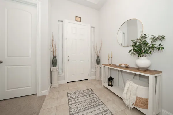 a room with painting and a potted plant