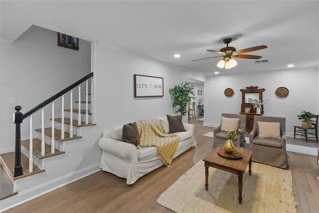 a living room with furniture and wooden floor