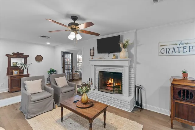 a living room with furniture a fireplace and a flat screen tv