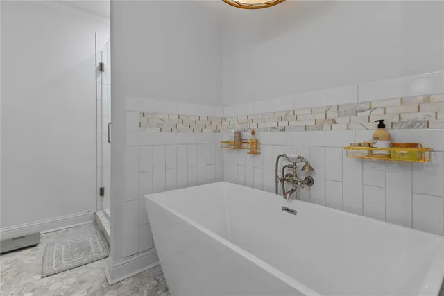 a bath tub sitting next to a bathroom sink