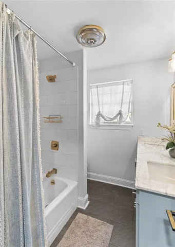 a bathroom with a sink a bathtub and a shower