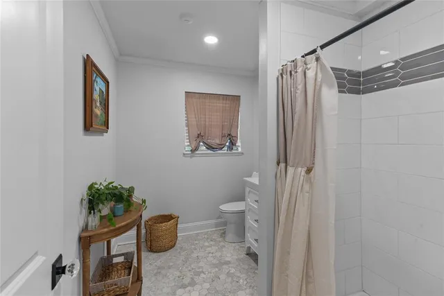 a bathroom with a toilet a sink and a shower