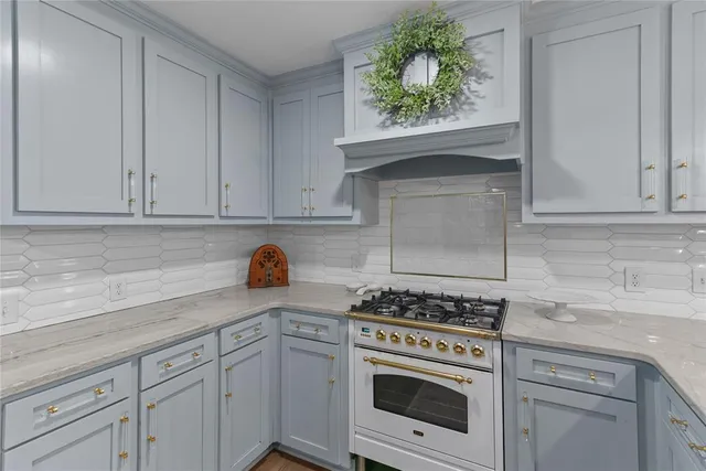 a kitchen with white cabinets and appliances