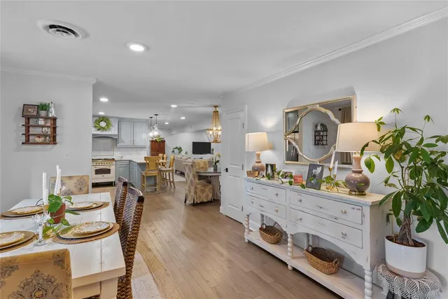 a view of a dining room with furniture and a potted plant
