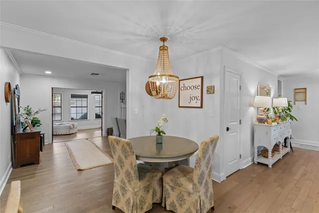 a view of a dining room with furniture wooden floor and a chandelier