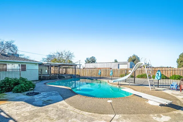 a view of a house with backyard porch and sitting area
