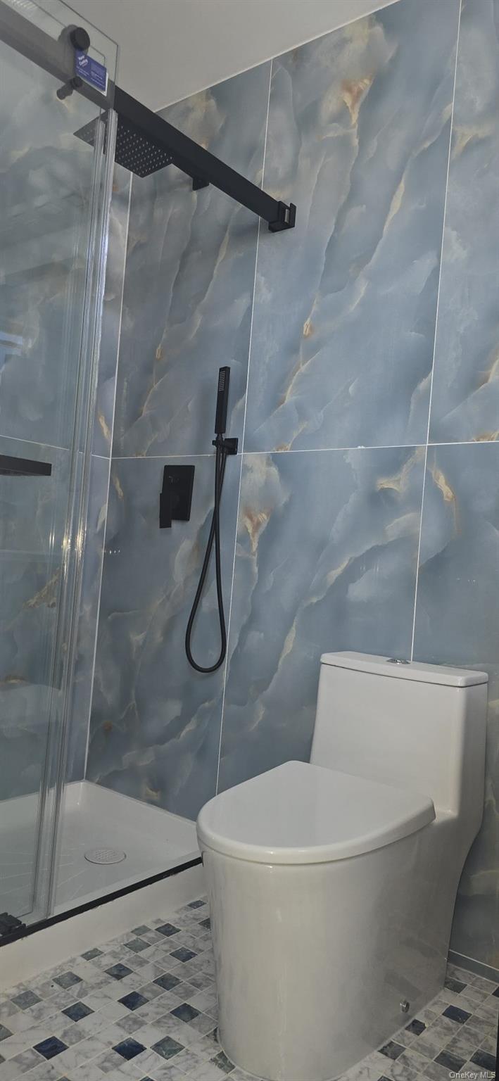 108-33 164th Street Queens, NY 11433 - Photo 17 of 20 a white bath tub sitting next to a toilet