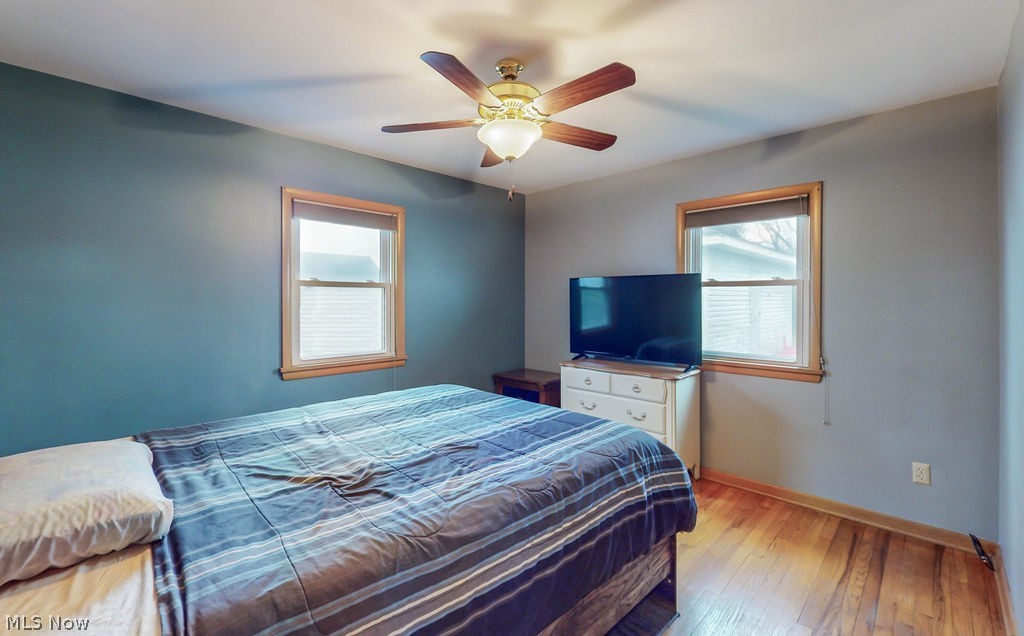 770 Yerrick Road Akron, OH 44312 - Photo 13 of 28 Bedroom with ceiling fan, light wood-type flooring, and multiple windows