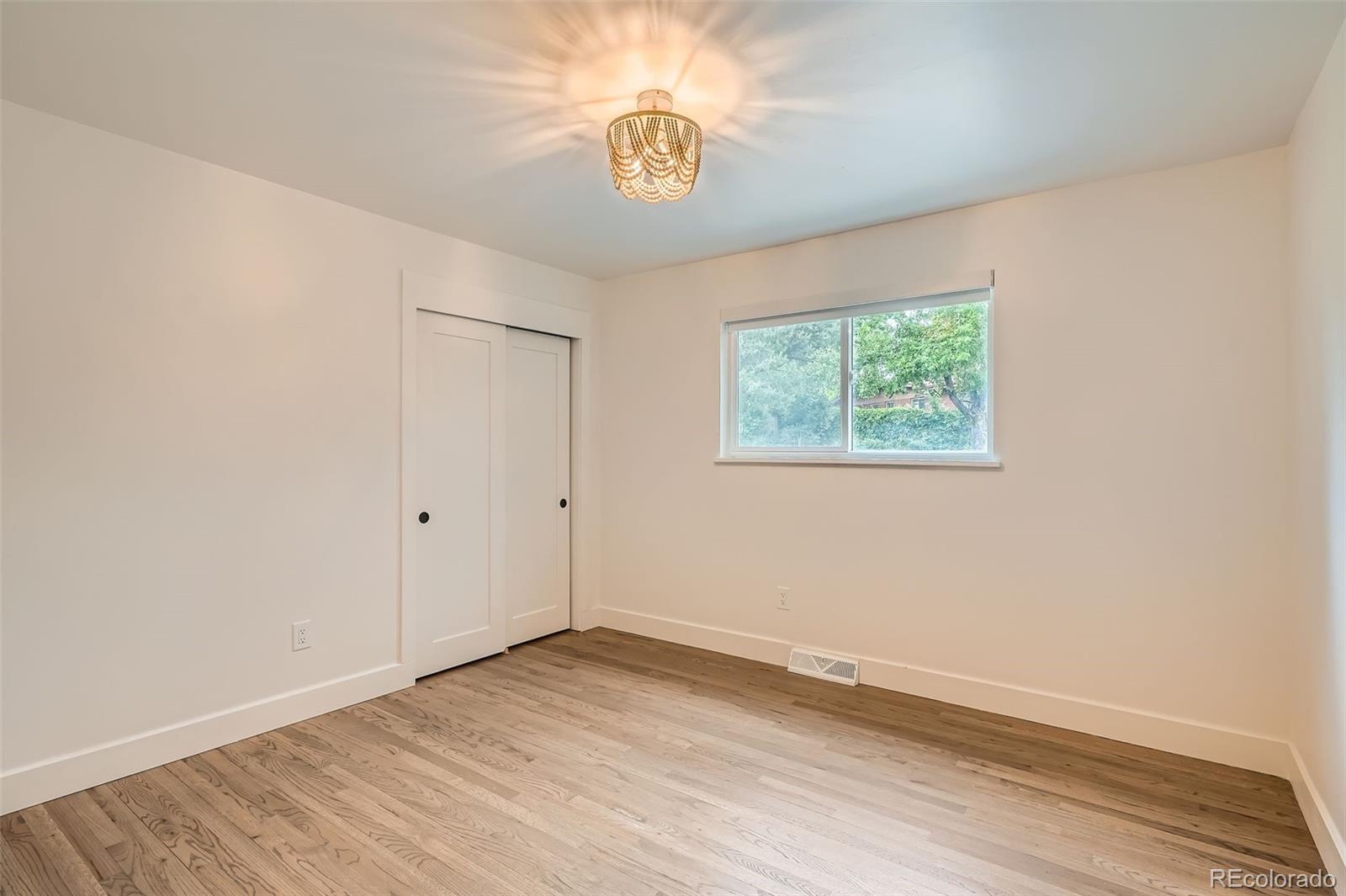 22 Rangeview Drive Wheat Ridge, CO 80215 - Photo 13 of 28 a view of an empty room with wooden floor and a window