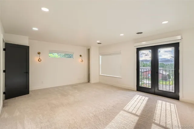 a view of an empty room with window and balcony