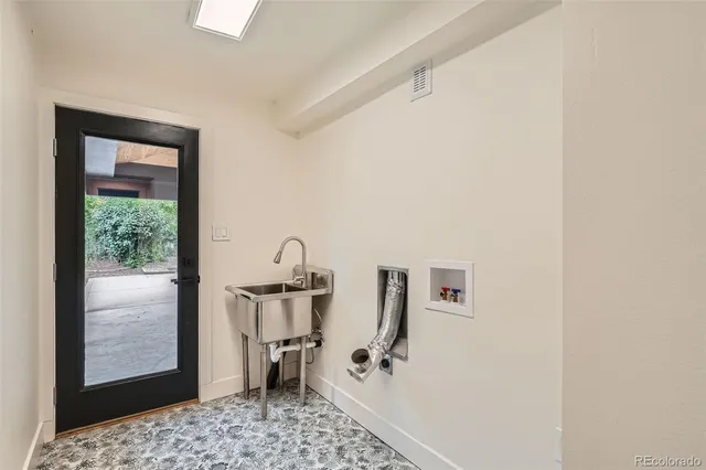 a view of a kitchen with refrigerator and wooden floor