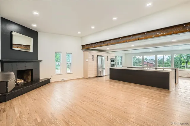 a view of kitchen and a fireplace with wooden floor