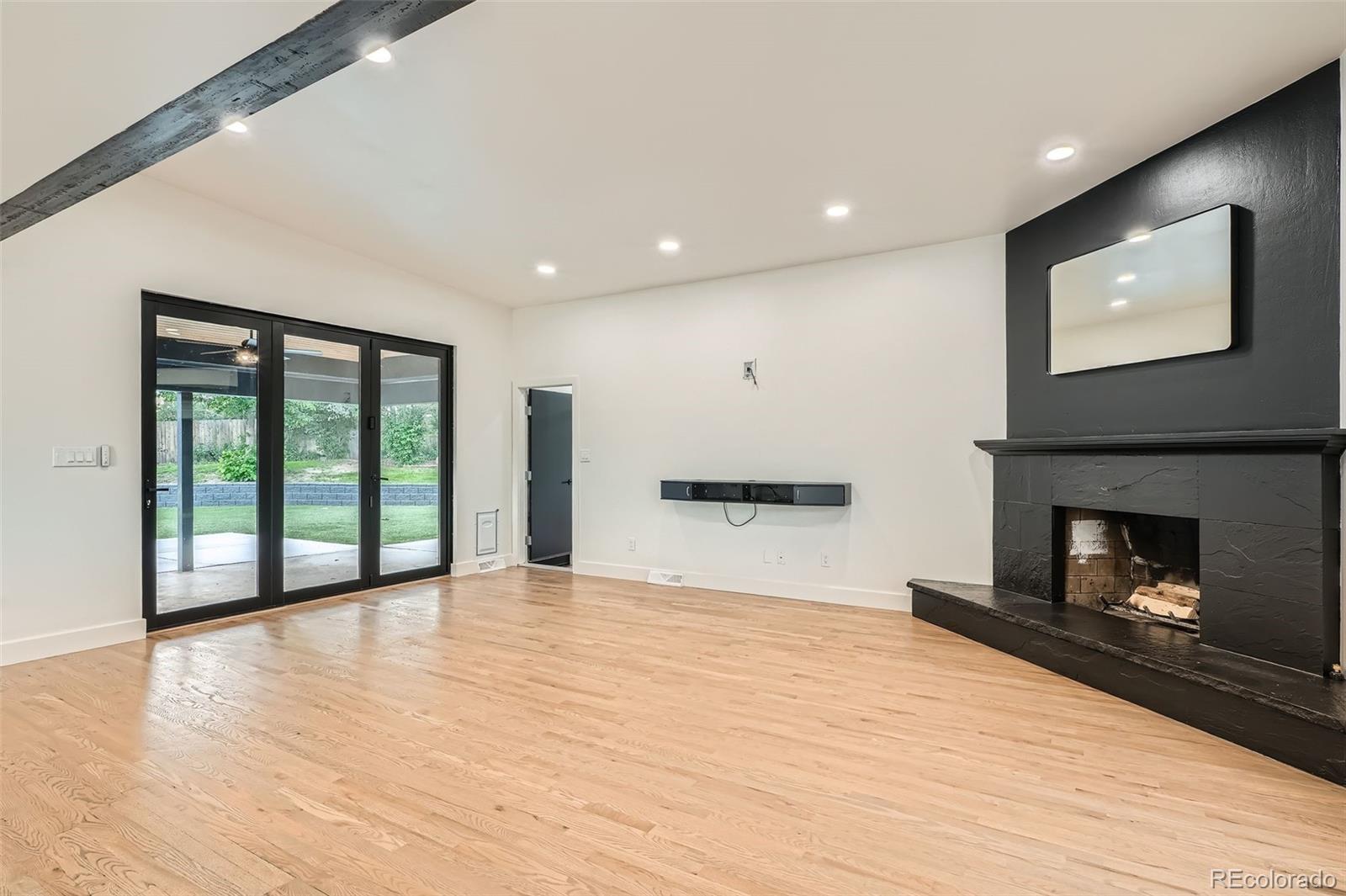 22 Rangeview Drive Wheat Ridge, CO 80215 - Photo 9 of 28 a view of an empty room with a fireplace and a window