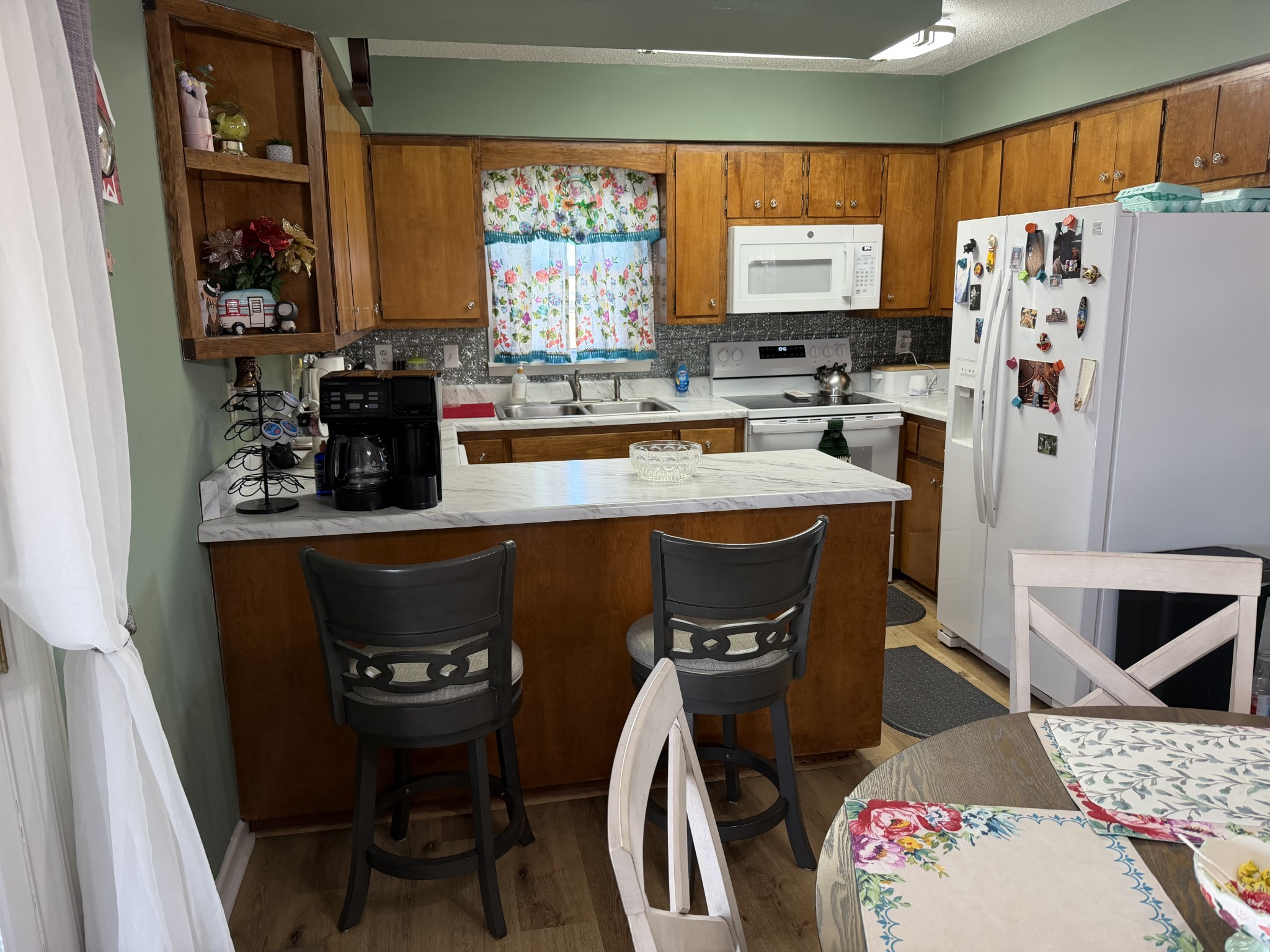 8 Mattox Road Lawrenceburg, TN 38464 - Photo 3 of 38 a kitchen with stainless steel appliances granite countertop a sink a microwave a refrigerator and chairs