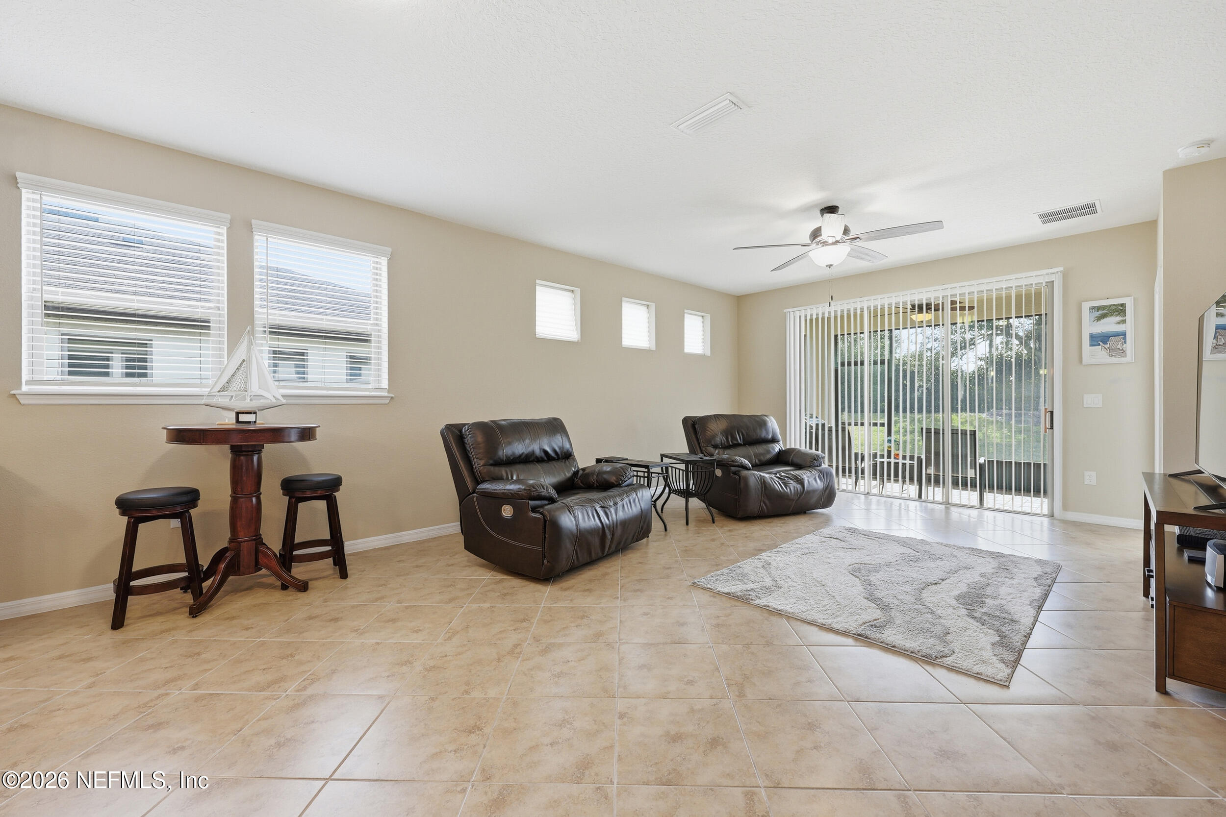 258 Rock Spring Loop St. Augustine, FL 32095 - Photo 11 of 31 a living room with furniture and a flat screen tv