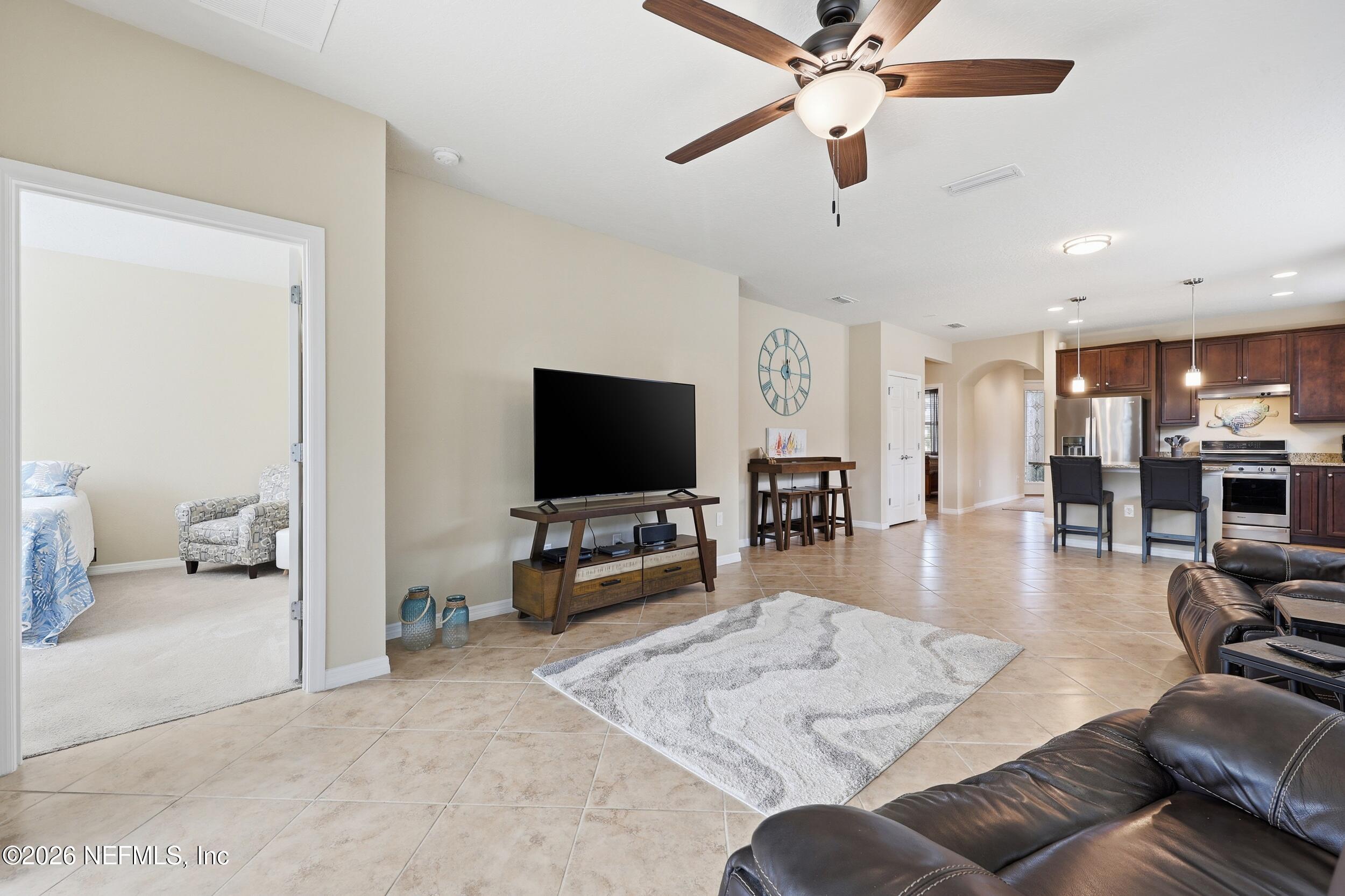 258 Rock Spring Loop St. Augustine, FL 32095 - Photo 13 of 31 a living room with furniture and a flat screen tv