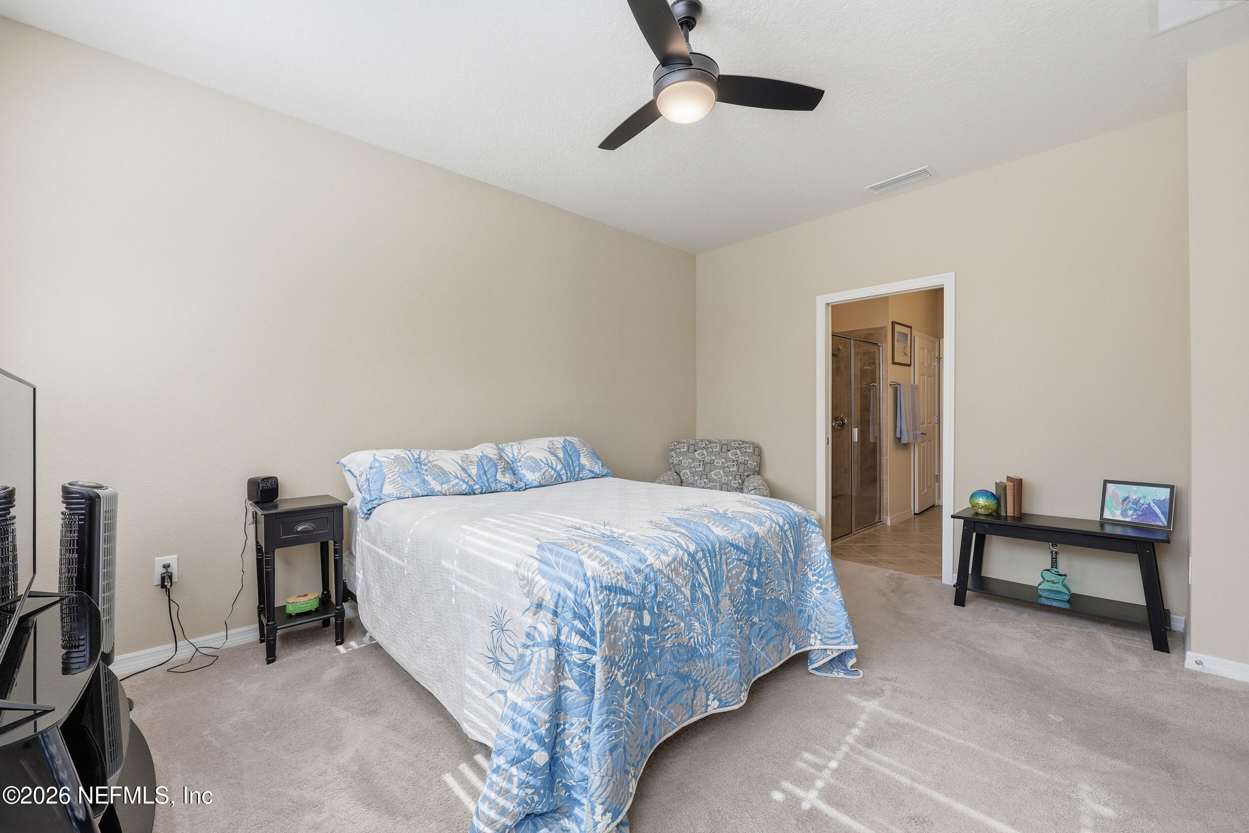 258 Rock Spring Loop St. Augustine, FL 32095 - Photo 15 of 31 a bedroom with a bed and a chair