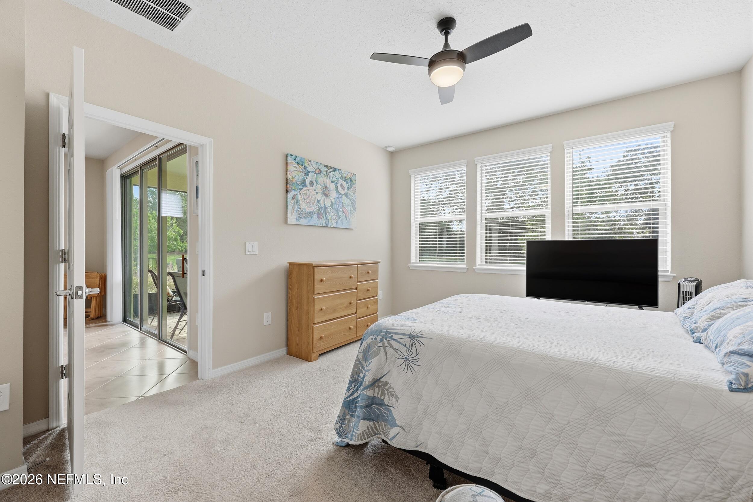 258 Rock Spring Loop St. Augustine, FL 32095 - Photo 17 of 31 a bedroom with a bed dresser and a window