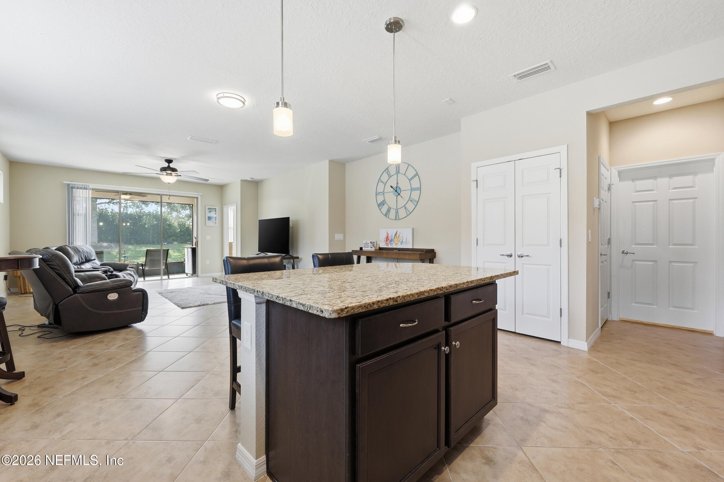 258 Rock Spring Loop St. Augustine, FL 32095 - Photo 6 of 31 a view of kitchen island and living room