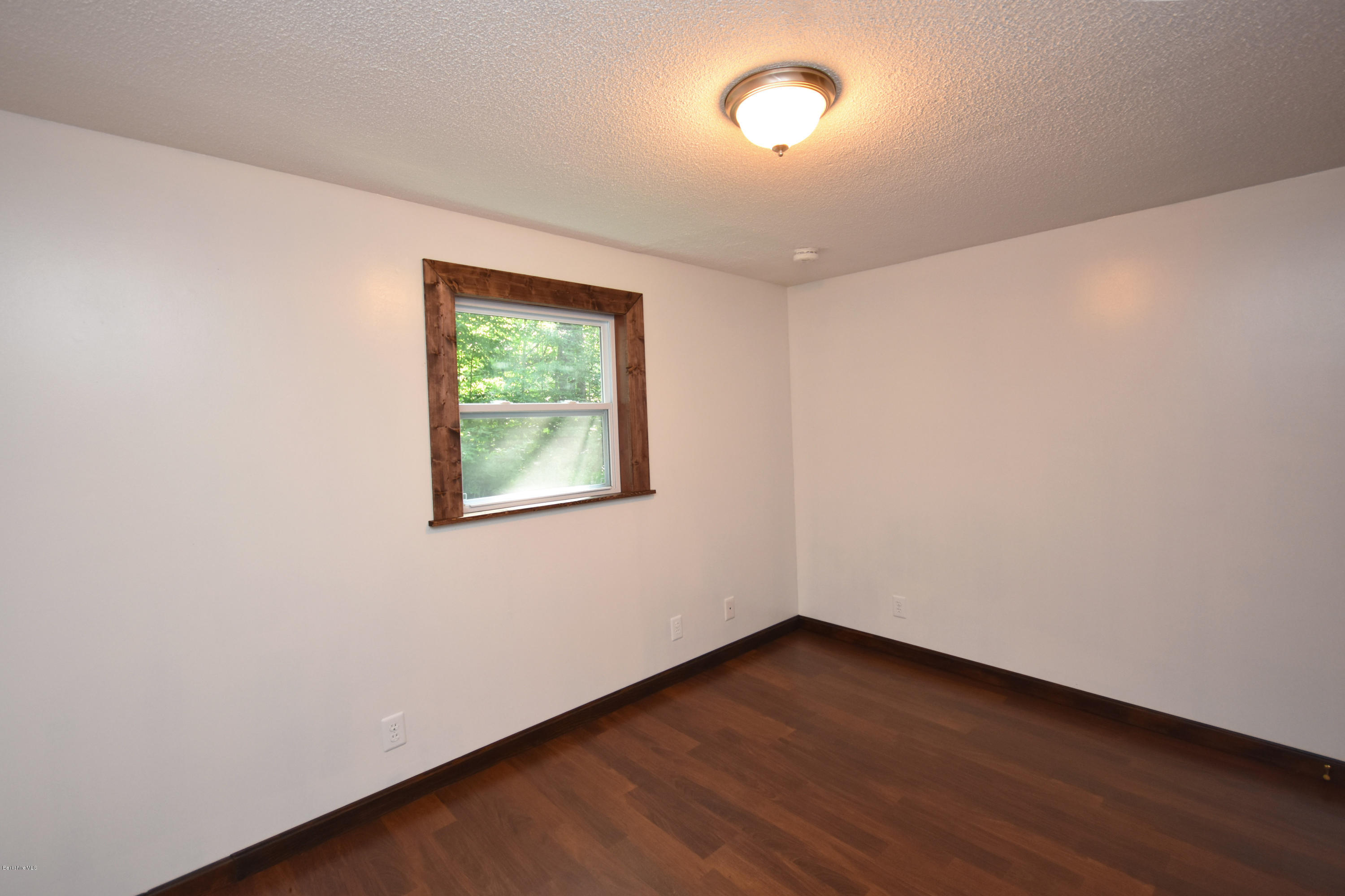 17 Raymond Road Peru, MA 01235 - Photo 22 of 57 an empty room with wooden floor and windows