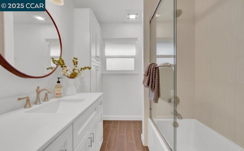 5434 Roundtree Court Concord, CA 94521 - Photo 17 of 23 a bathroom with a sink and mirror with bathtub