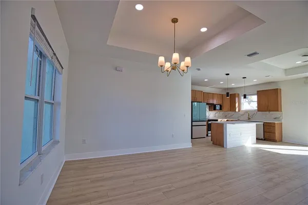 a view of a kitchen and a sink dishwasher wooden floor and a fireplace