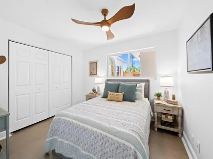 a bedroom with a bed and a painting on the wall