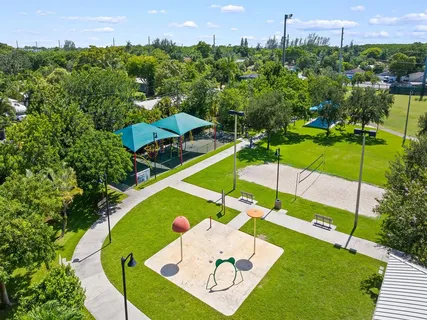 an aerial view of residential houses with outdoor space and swimming pool