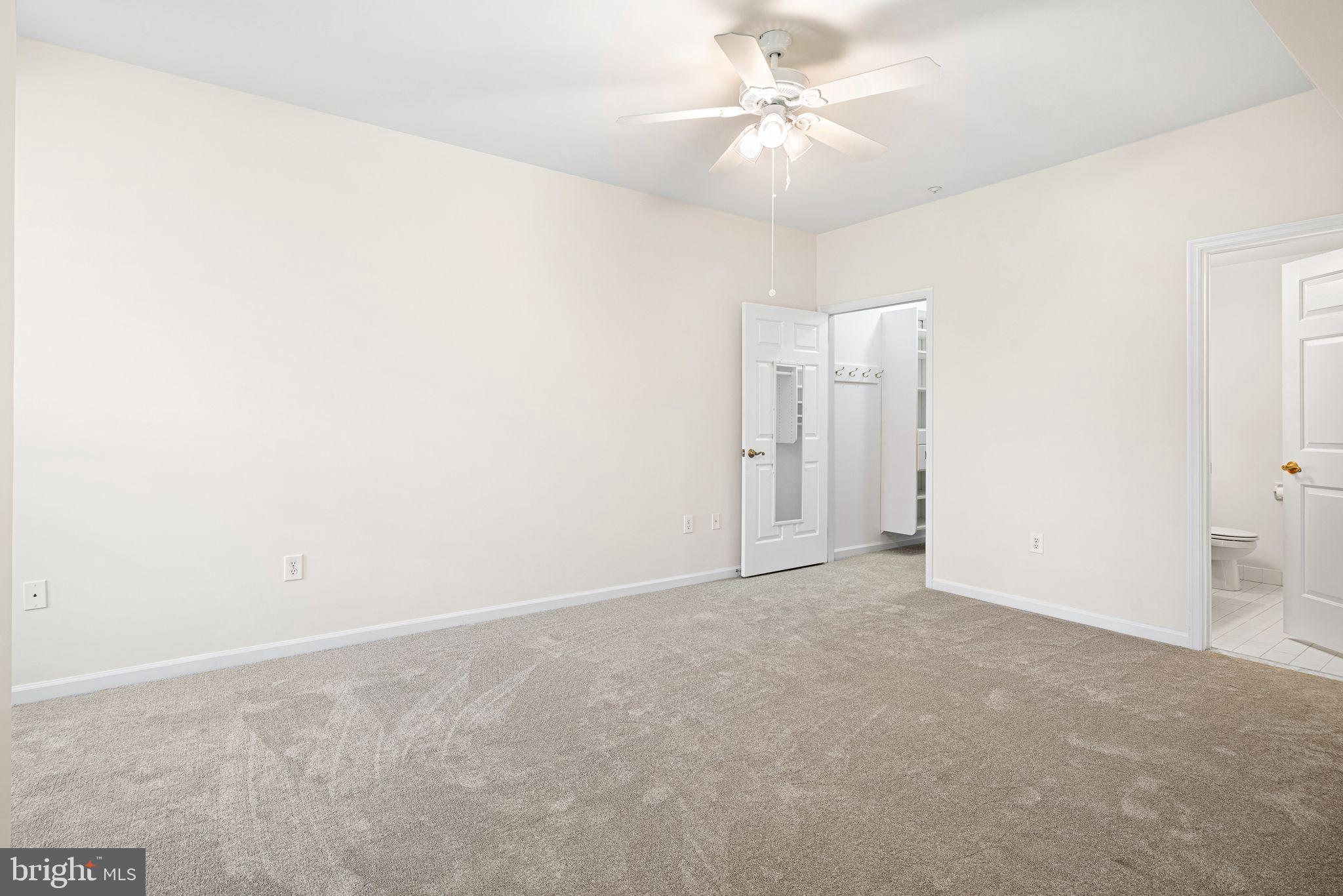 1364 Nicklaus Drive Springfield, PA 19064 - Photo 20 of 25 an empty room with a chandelier fan and windows