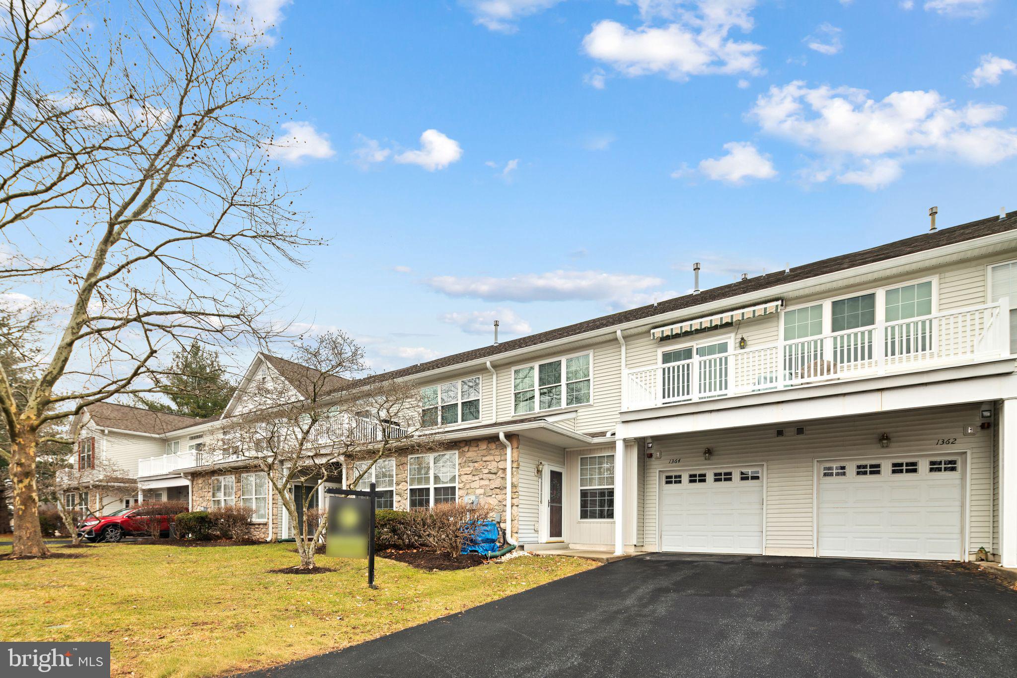 1364 Nicklaus Drive Springfield, PA 19064 - Photo 2 of 25 a front view of a building with lot of cars and trees