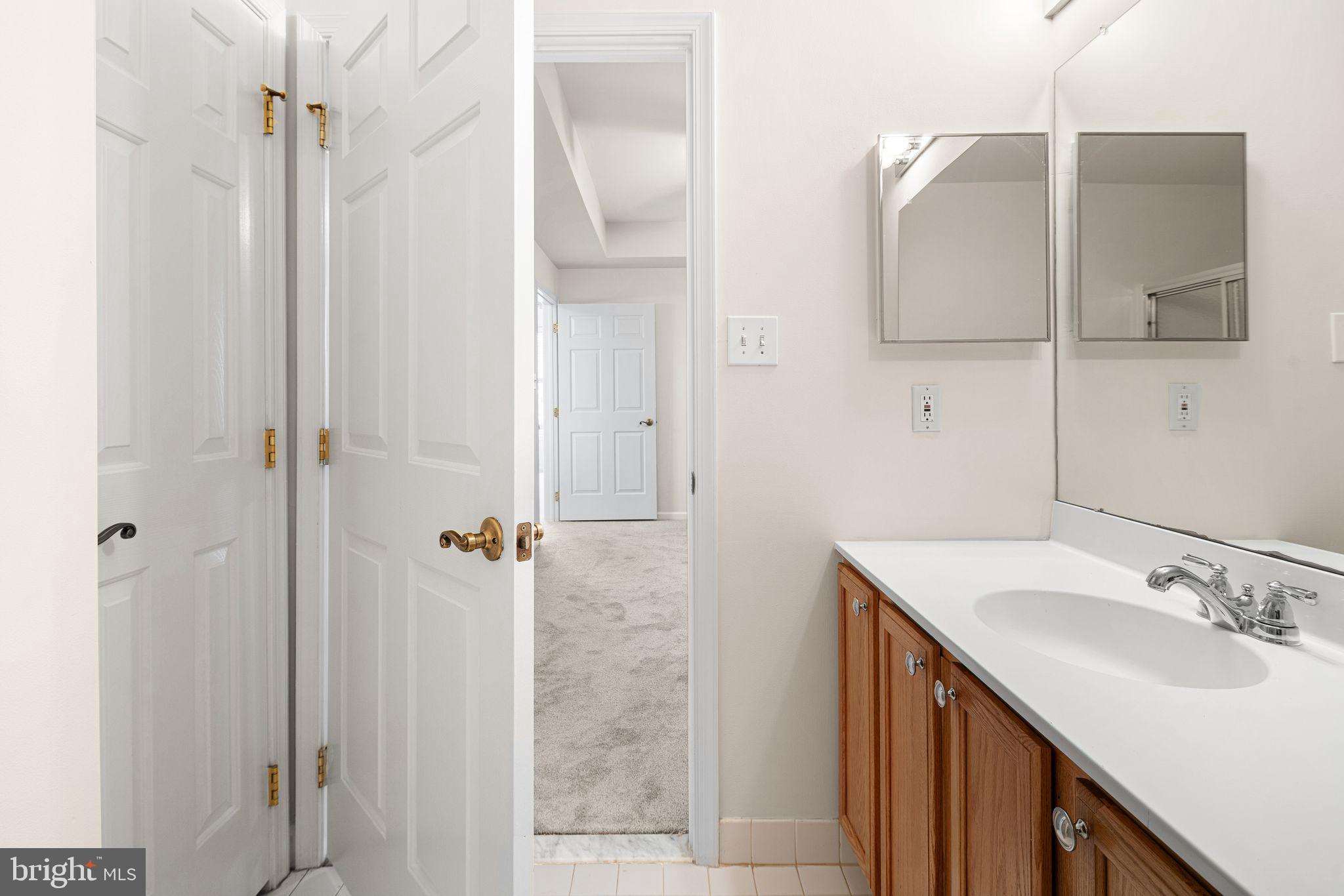 1364 Nicklaus Drive Springfield, PA 19064 - Photo 24 of 25 a bathroom with a sink vanity granite shower and a mirror