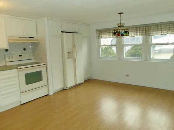a view of a kitchen with a sink dishwasher and wooden floor
