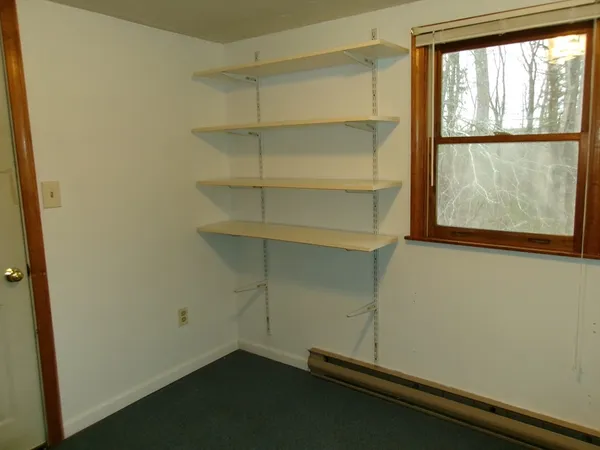 a room with a wooden floor and a window