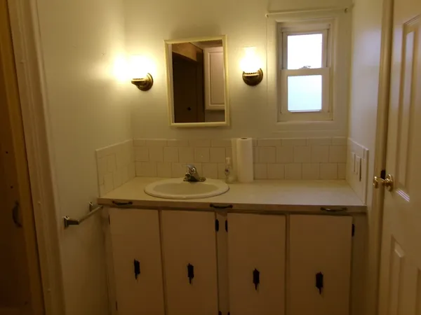a bathroom with a sink and mirror