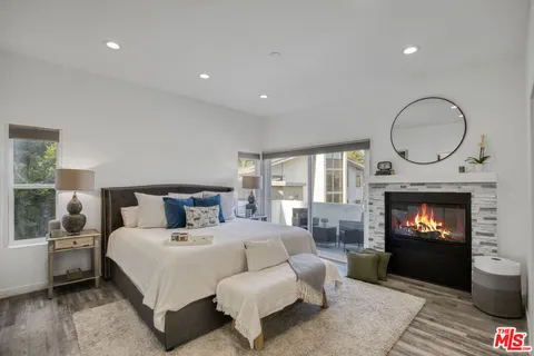 a bedroom with a bed and a fireplace