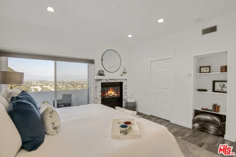 a bedroom with a bed and a fireplace