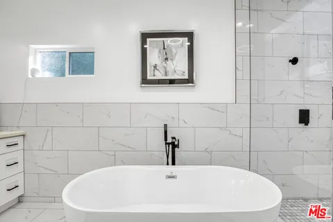 a white bath tub sitting in a bathroom