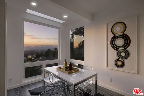 a view of a workspace with furniture and wooden floor